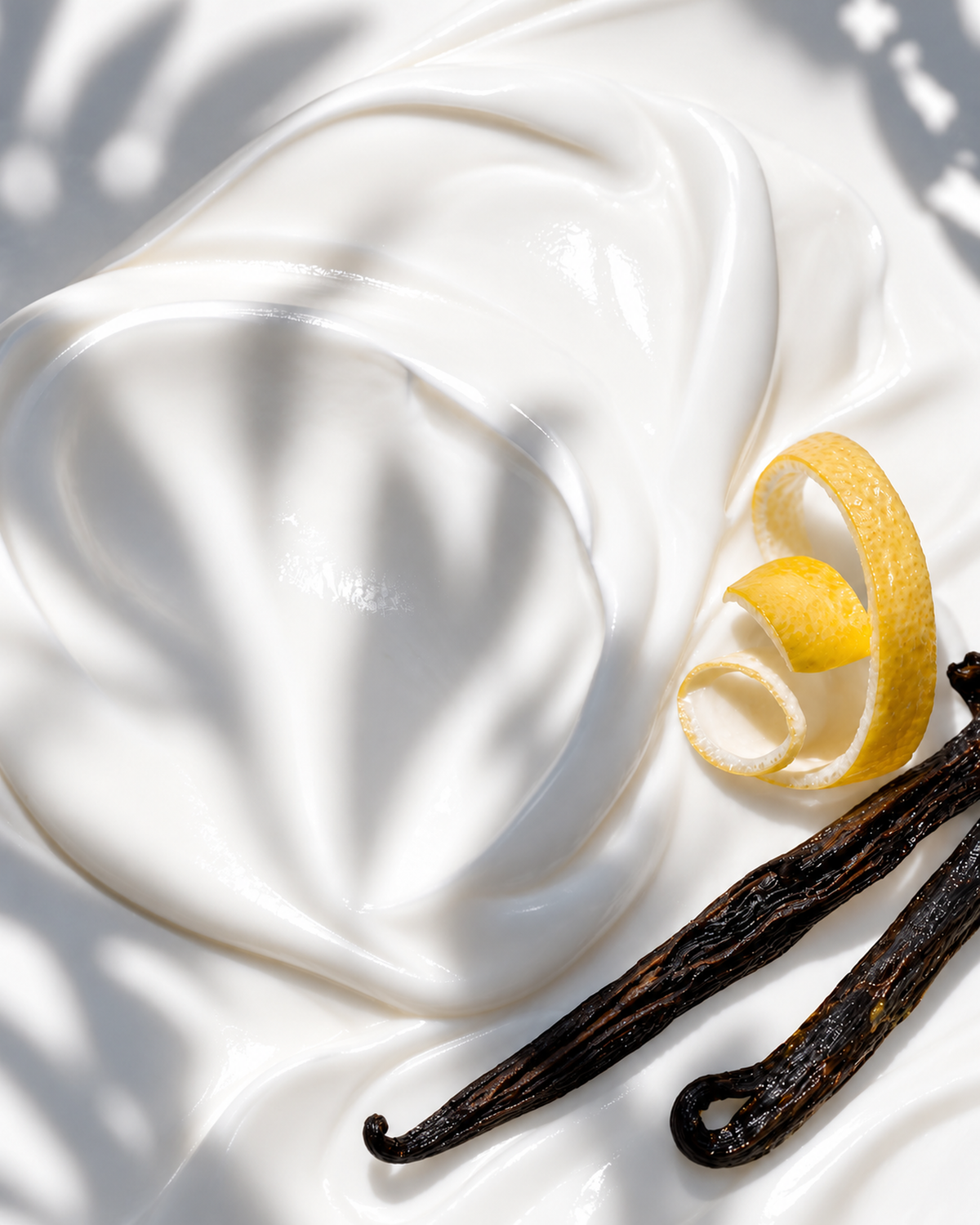 Silky white cream folds with curled lemon peel and vanilla pods