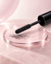 Lash fiber applicator on pearl-pink optical glass with fine dry fibers.